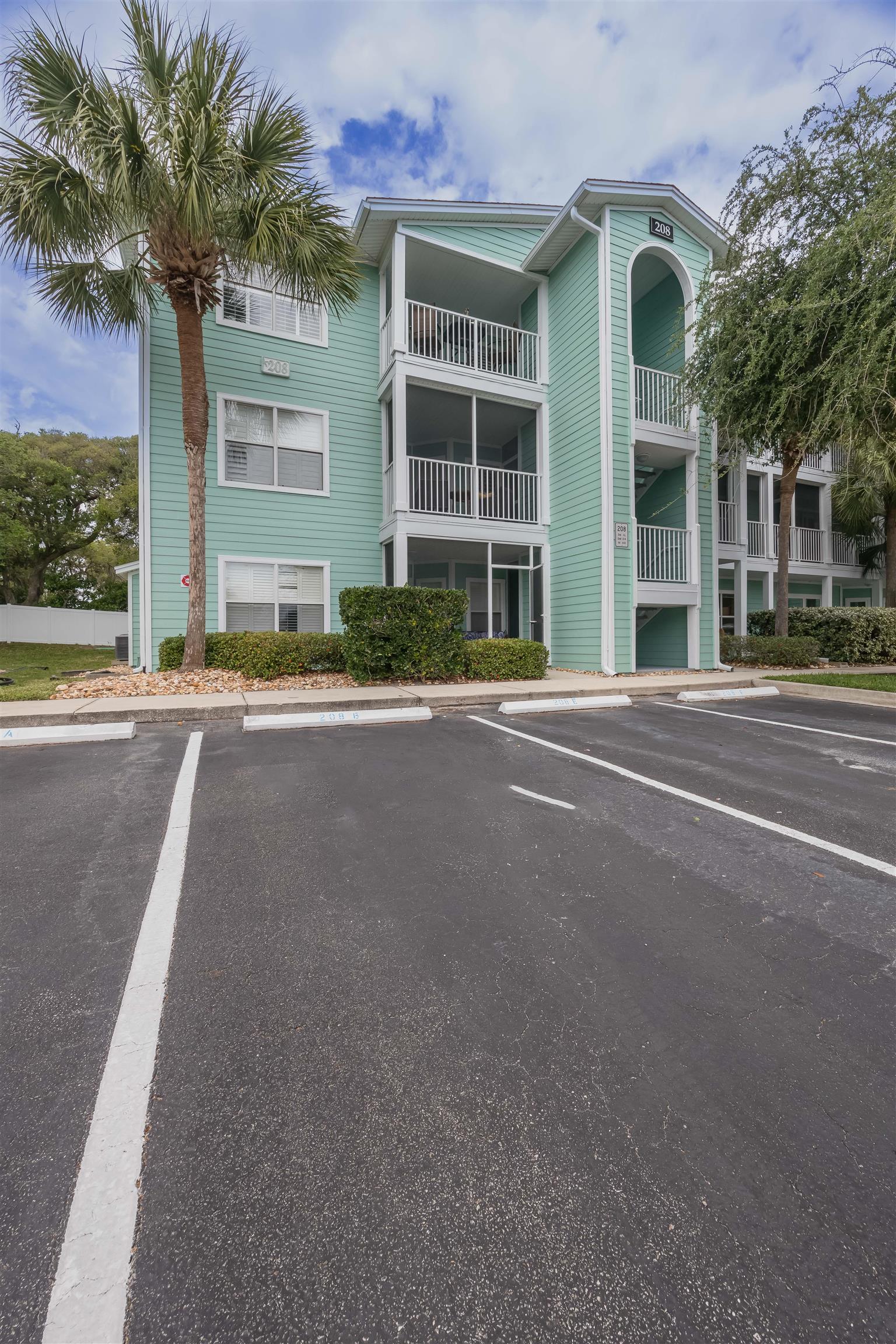 208 16th Street, Unit B St. Augustine, FL 32080 - Photo 29 of 68 a front view of a building with a road and plants