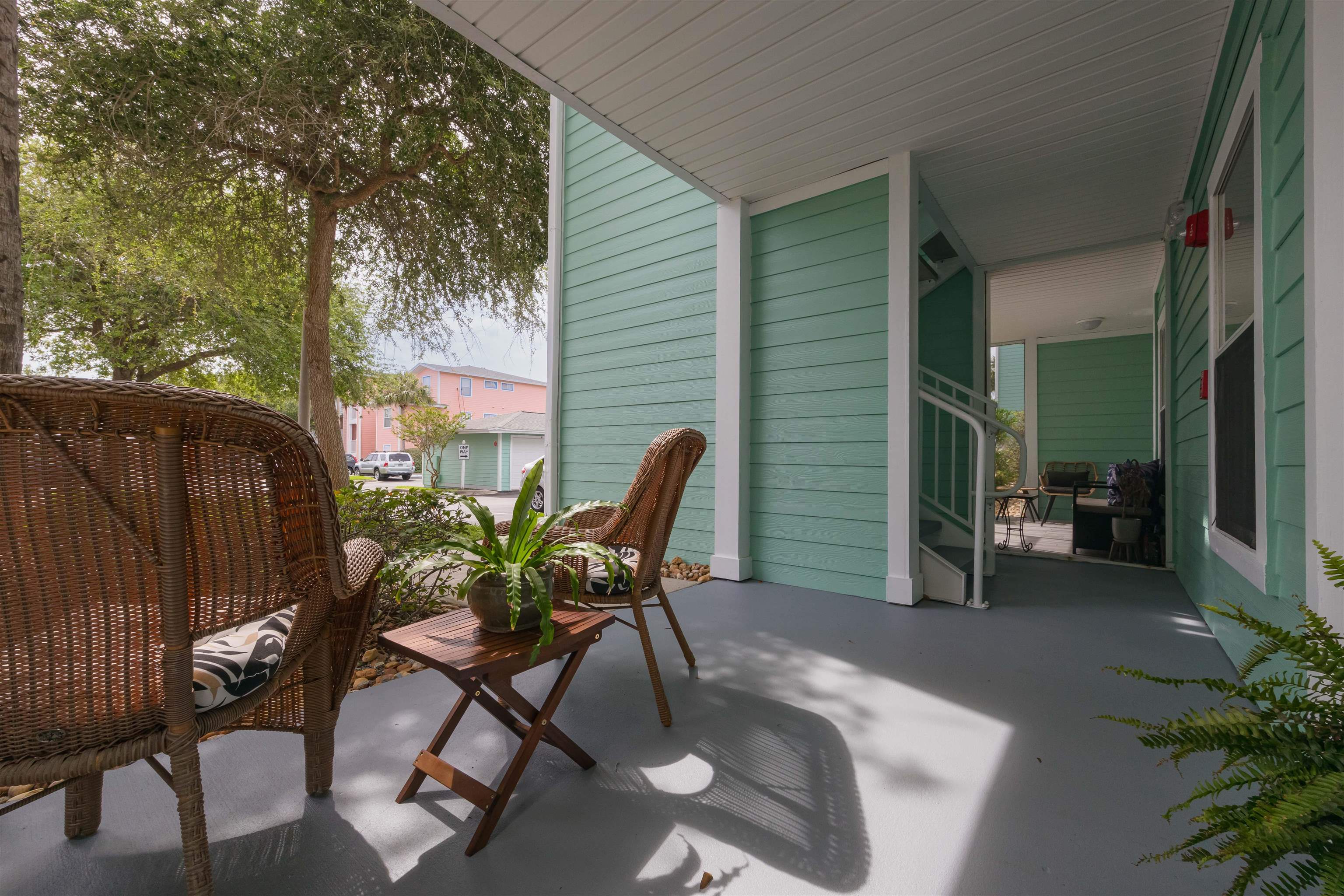 208 16th Street, Unit B St. Augustine, FL 32080 - Photo 6 of 68 a patio with table and chairs and potted plants