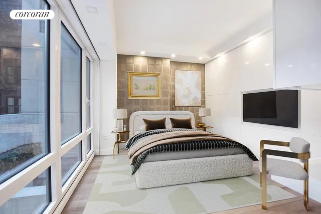 a bedroom with a bed and a flat screen tv