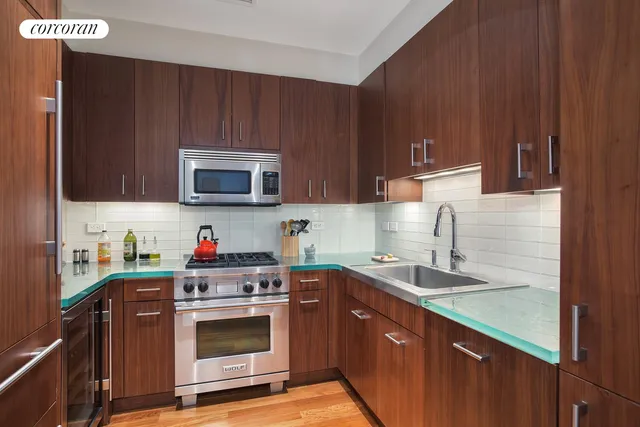 a kitchen with stainless steel appliances granite countertop a sink stove and microwave