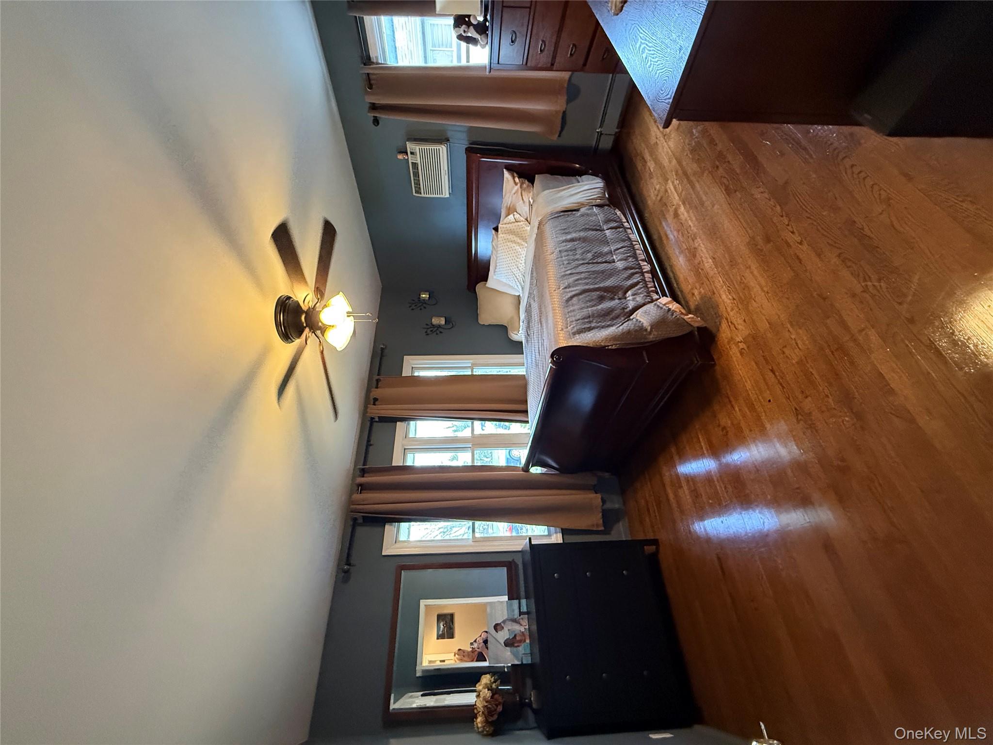 1009 Huckleberry Road North Bellmore, NY 11710 - Photo 11 of 24 a bedroom with a bed and a chandelier