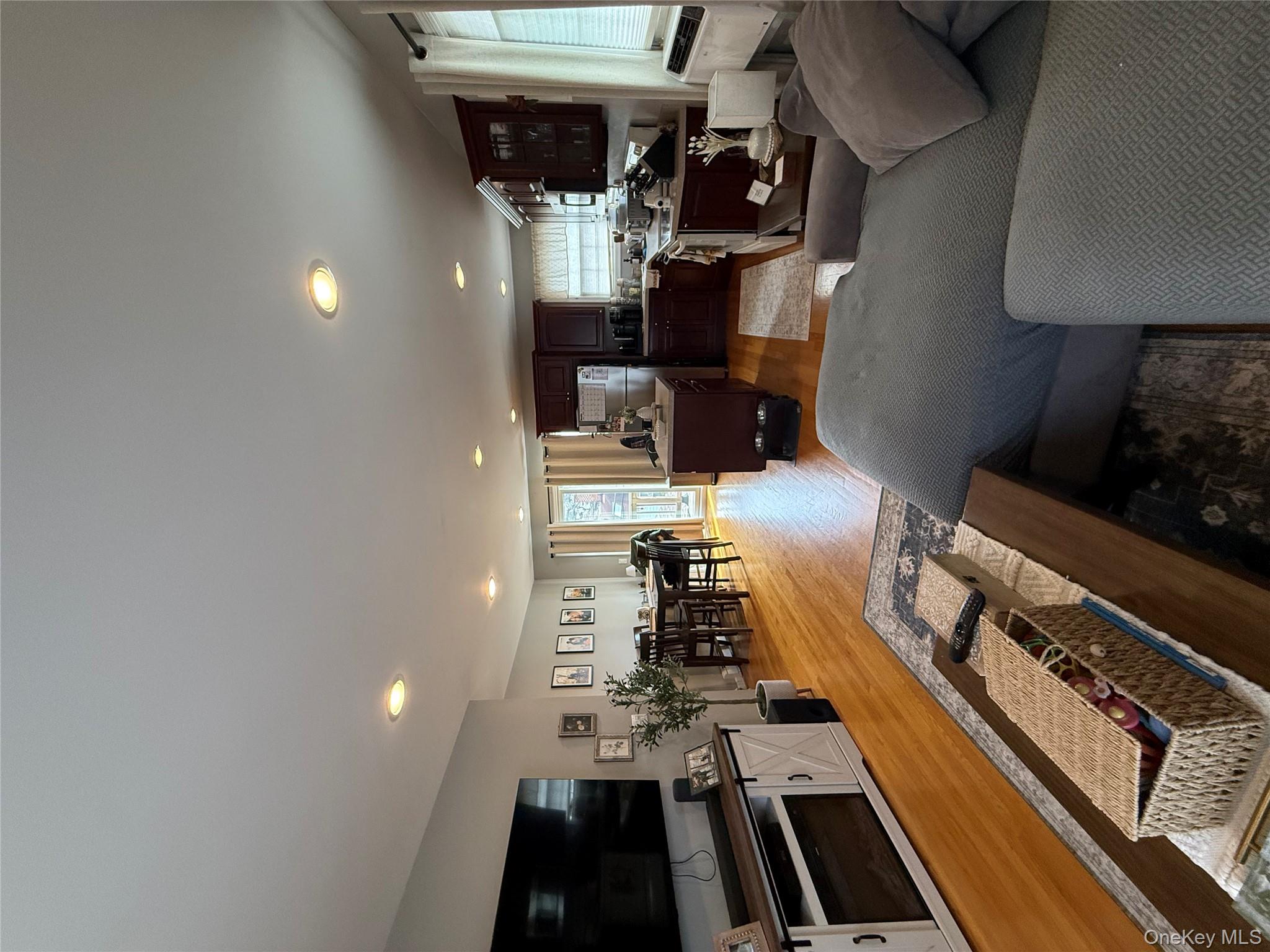 1009 Huckleberry Road North Bellmore, NY 11710 - Photo 14 of 24 a living room with furniture and a flat screen tv