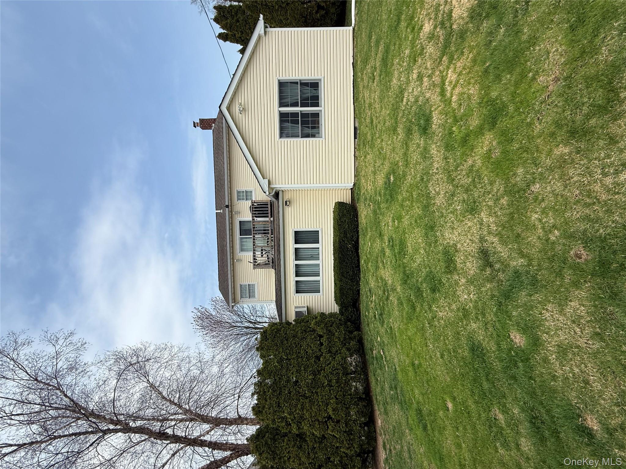 1009 Huckleberry Road North Bellmore, NY 11710 - Photo 20 of 24 a front view of a house with a yard