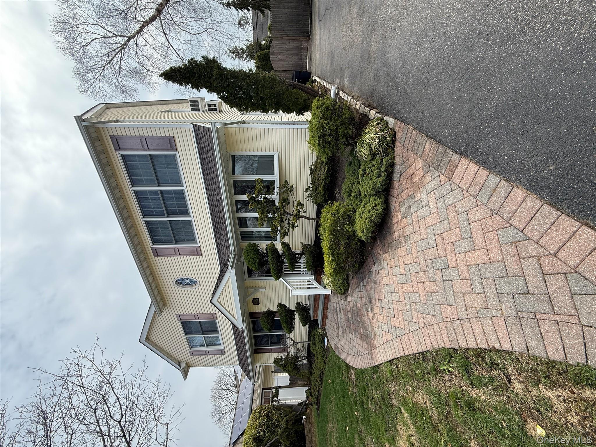 1009 Huckleberry Road North Bellmore, NY 11710 - Photo 2 of 24 a front view of a house with garden