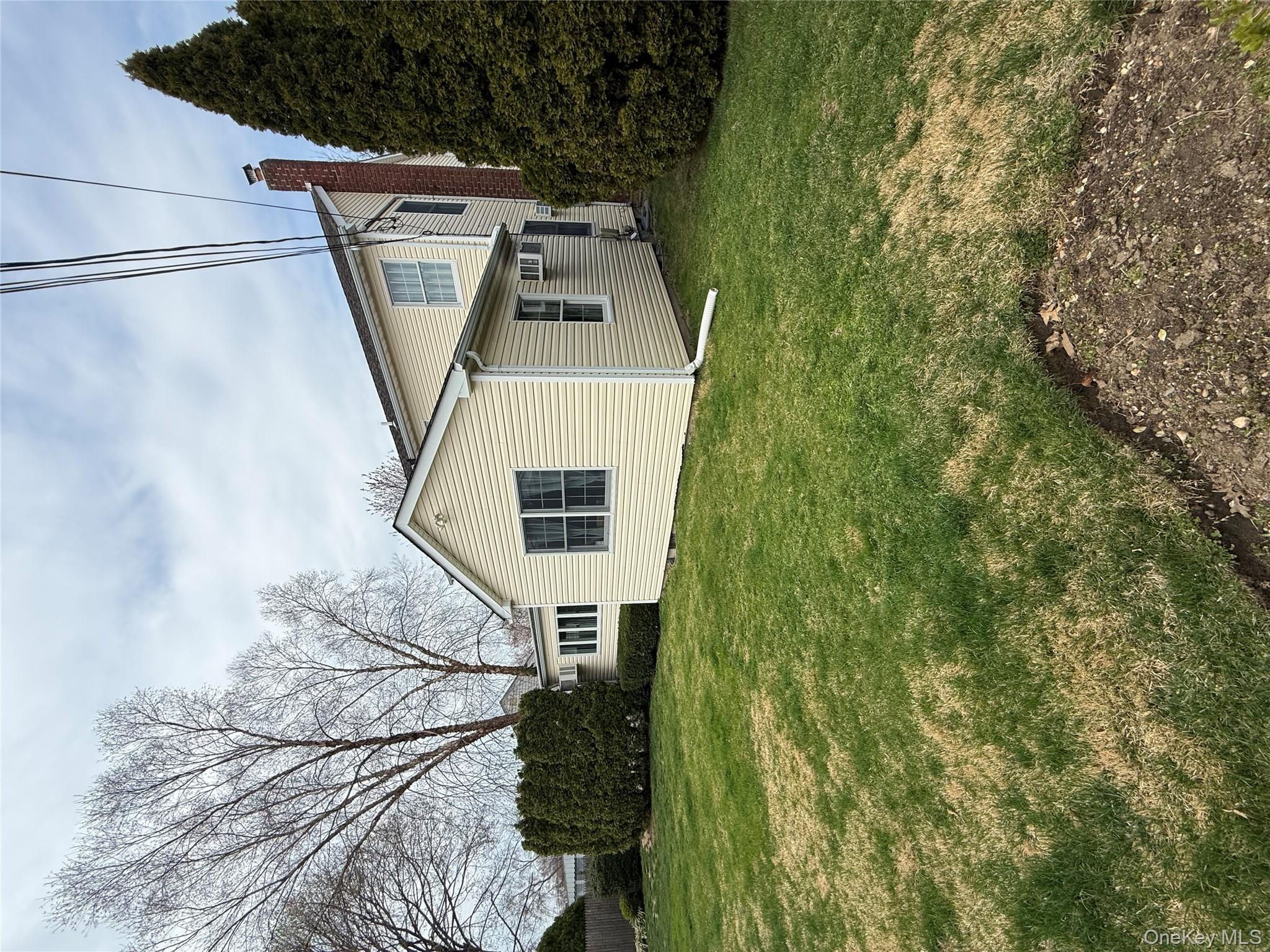 1009 Huckleberry Road North Bellmore, NY 11710 - Photo 22 of 24 a view of a house with a yard