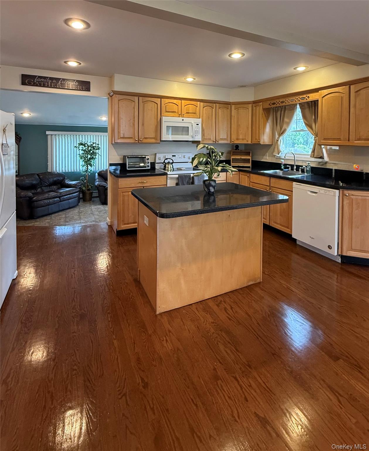 1009 Huckleberry Road North Bellmore, NY 11710 - Photo 3 of 24 a kitchen with granite countertop a stove and cabinets