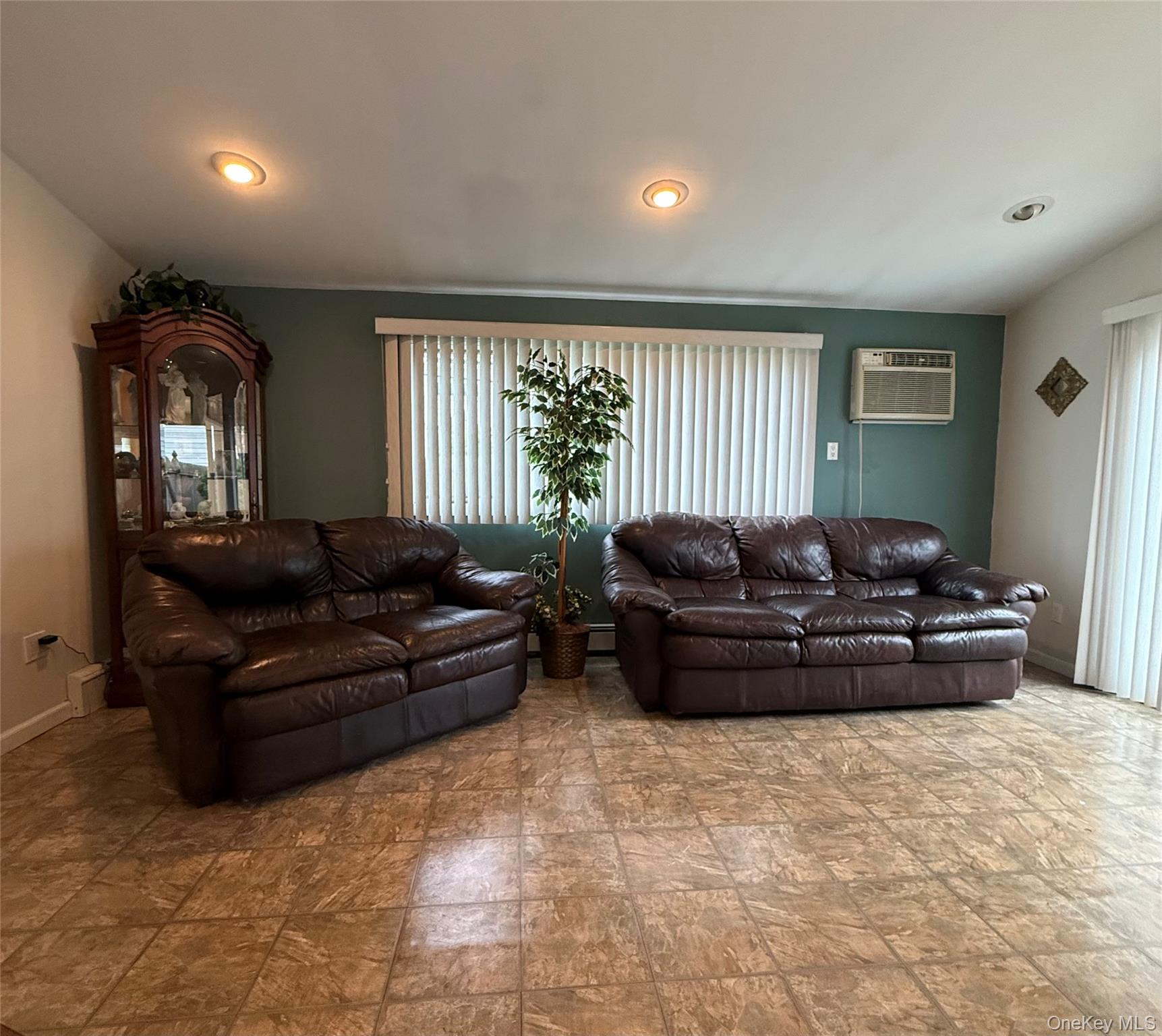 1009 Huckleberry Road North Bellmore, NY 11710 - Photo 6 of 24 a living room with furniture and a large window
