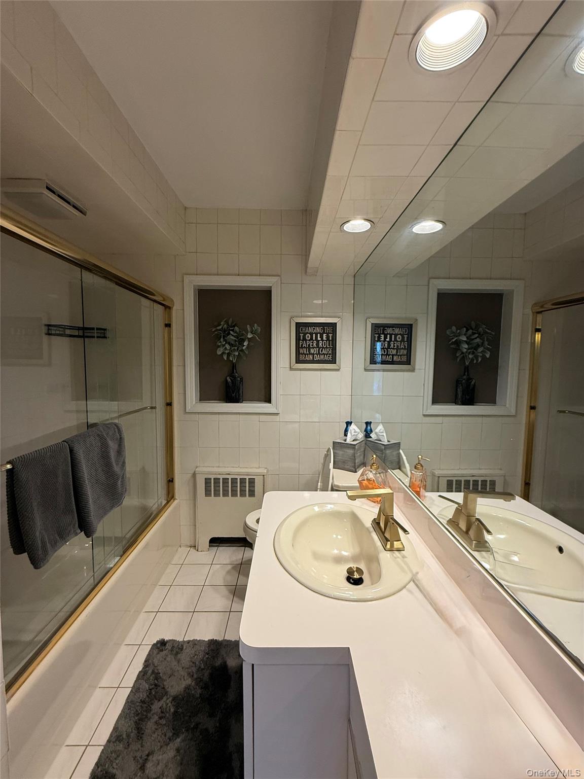 1009 Huckleberry Road North Bellmore, NY 11710 - Photo 7 of 24 a bathroom with a sink and mirror