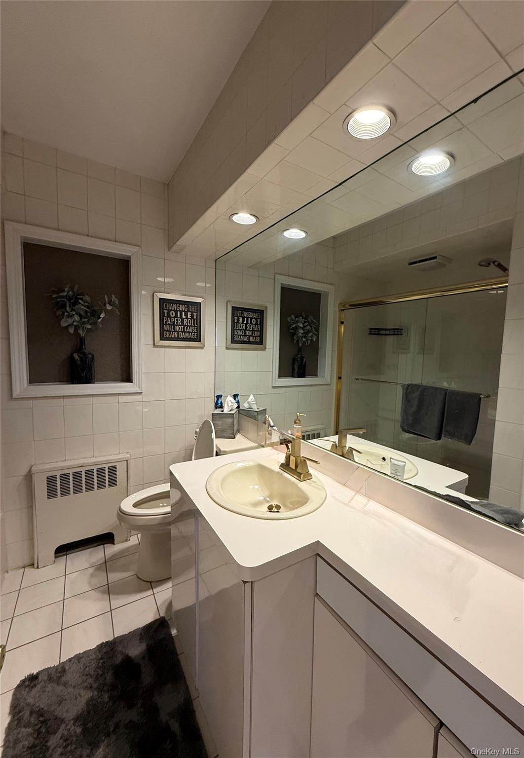 1009 Huckleberry Road North Bellmore, NY 11710 - Photo 8 of 24 a bathroom with a sink and a mirror