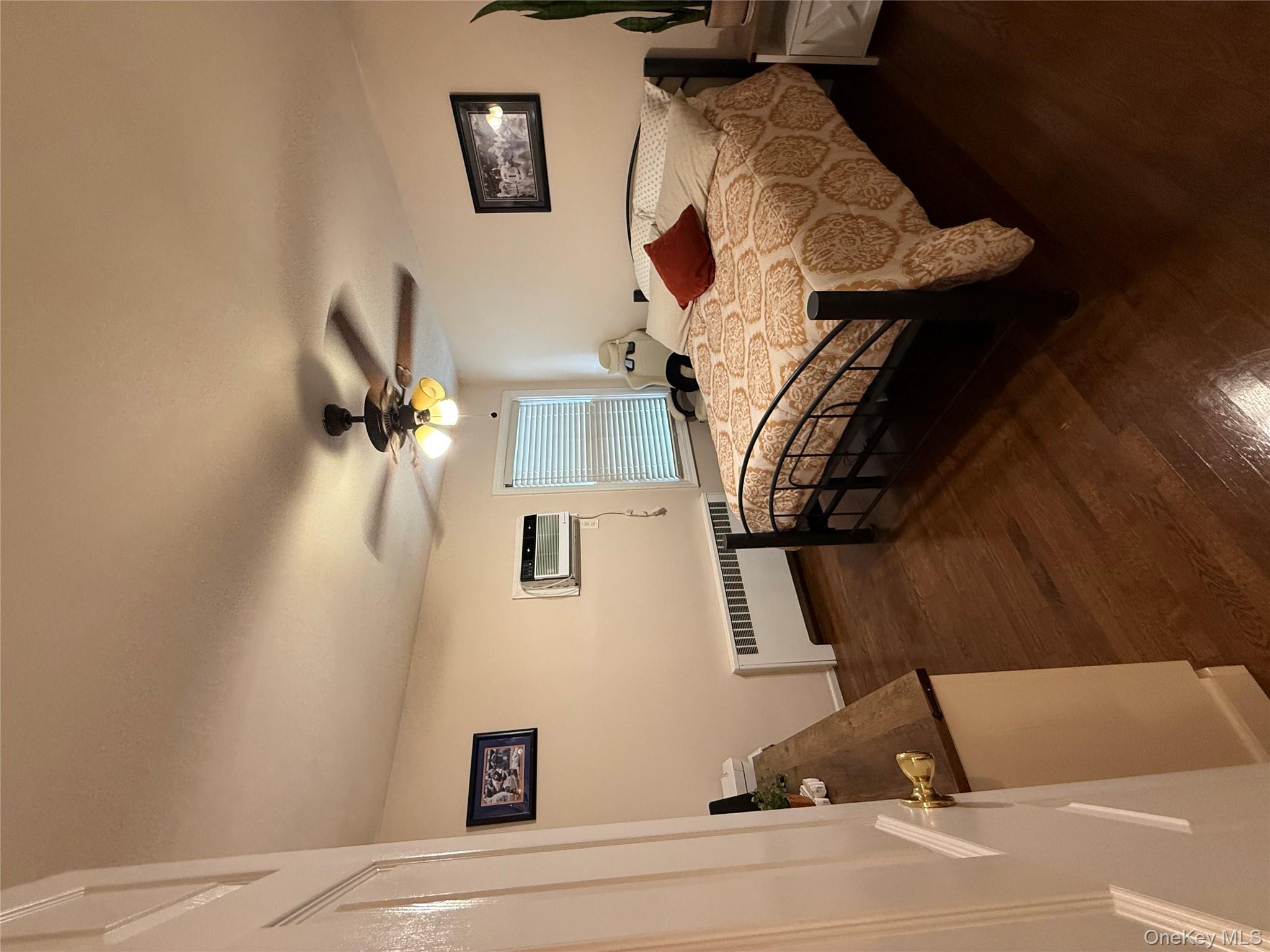 1009 Huckleberry Road North Bellmore, NY 11710 - Photo 10 of 24 a bedroom with a bed and wooden floor