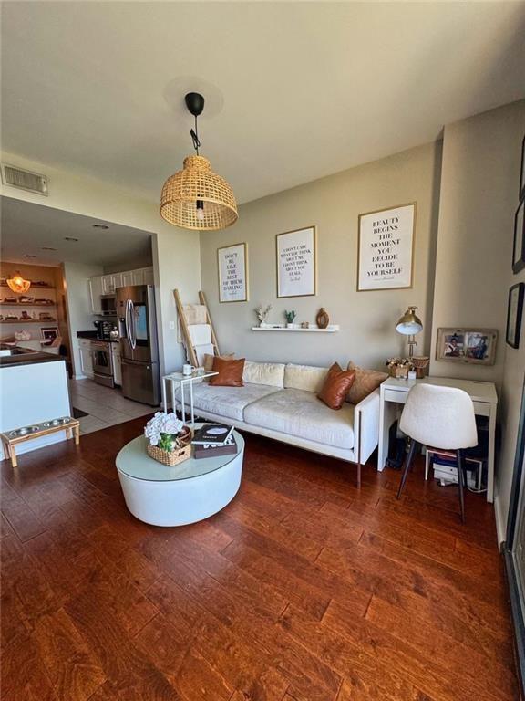 3040 Peachtree Road Northwest, Unit 707 Atlanta, GA 30305 - Photo 13 of 38 a living room with furniture and a chandelier