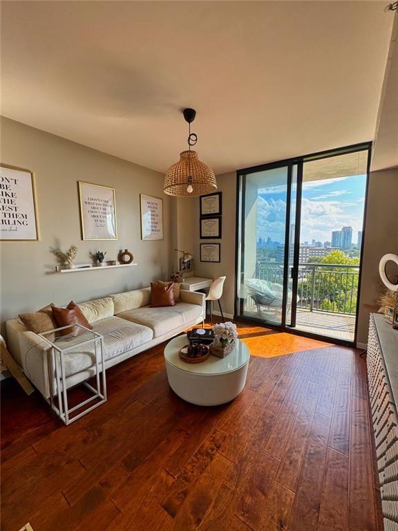 3040 Peachtree Road Northwest, Unit 707 Atlanta, GA 30305 - Photo 14 of 38 a living room with furniture and a large window