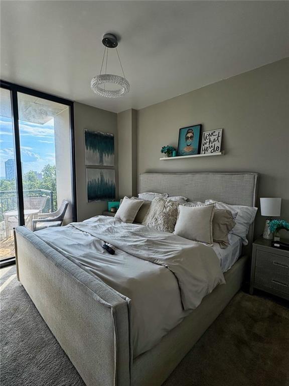 3040 Peachtree Road Northwest, Unit 707 Atlanta, GA 30305 - Photo 16 of 38 a bed sitting in a bedroom next to a window