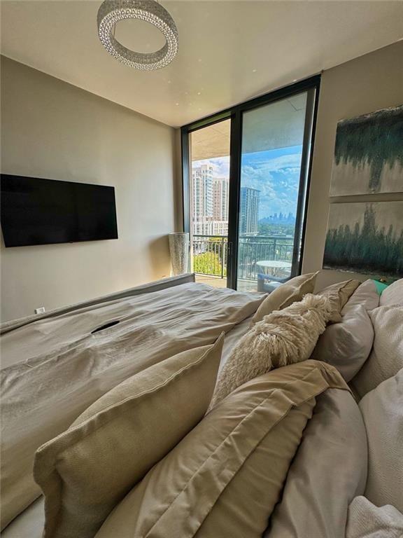 3040 Peachtree Road Northwest, Unit 707 Atlanta, GA 30305 - Photo 17 of 38 a bed sitting in a bedroom next to a window