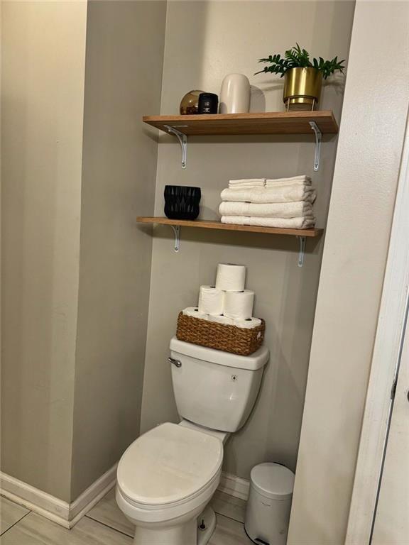 3040 Peachtree Road Northwest, Unit 707 Atlanta, GA 30305 - Photo 19 of 38 a white toilet sitting next to a sink and vanity