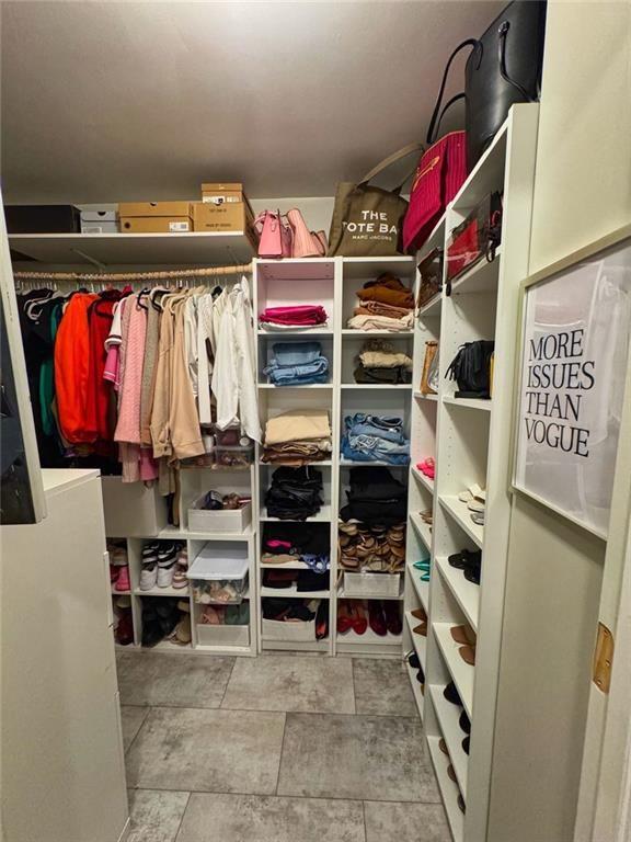 3040 Peachtree Road Northwest, Unit 707 Atlanta, GA 30305 - Photo 24 of 38 a view of walk in closet with clothes and shoes