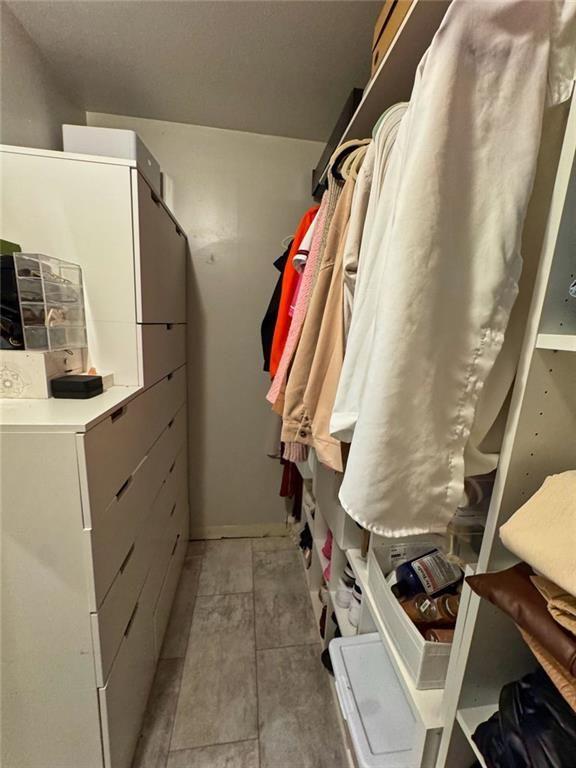 3040 Peachtree Road Northwest, Unit 707 Atlanta, GA 30305 - Photo 25 of 38 a view of walk in closet with clothes and shoes
