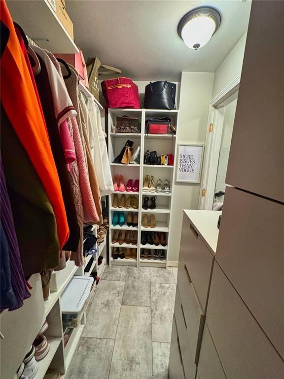 3040 Peachtree Road Northwest, Unit 707 Atlanta, GA 30305 - Photo 26 of 38 a view of walk in closet with clothes and shoes