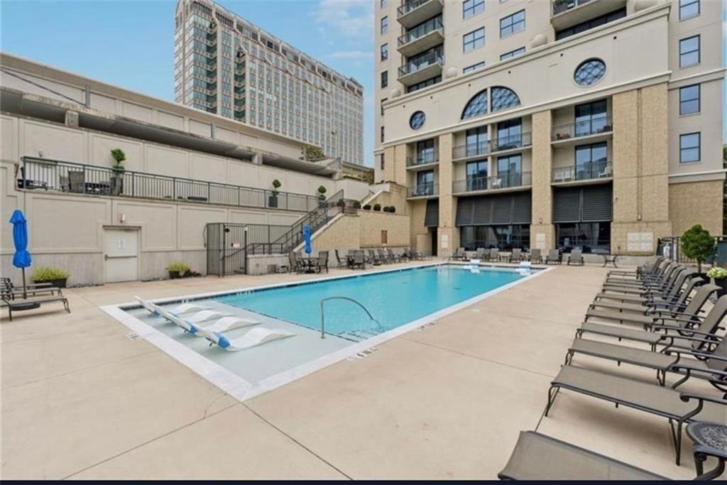 3040 Peachtree Road Northwest, Unit 707 Atlanta, GA 30305 - Photo 30 of 38 a view of a kitchen with stainless steel appliances granite countertop a sink and cabinets