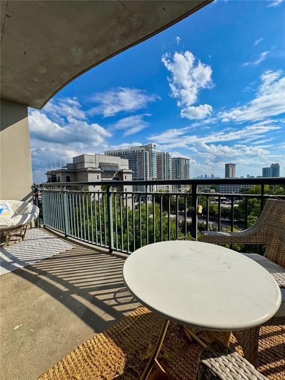 3040 Peachtree Road Northwest, Unit 707 Atlanta, GA 30305 - Photo 3 of 38 a view of a balcony dining table and chairs