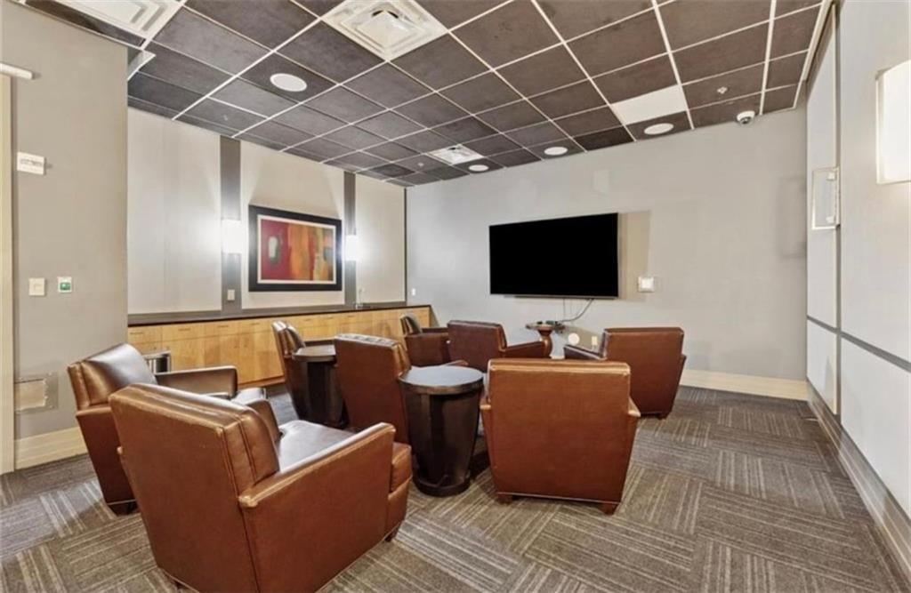 3040 Peachtree Road Northwest, Unit 707 Atlanta, GA 30305 - Photo 31 of 38 a living room with furniture and a flat screen tv