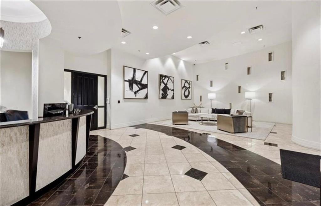 3040 Peachtree Road Northwest, Unit 707 Atlanta, GA 30305 - Photo 32 of 38 a large white kitchen with lots of counter space and stainless steel appliances