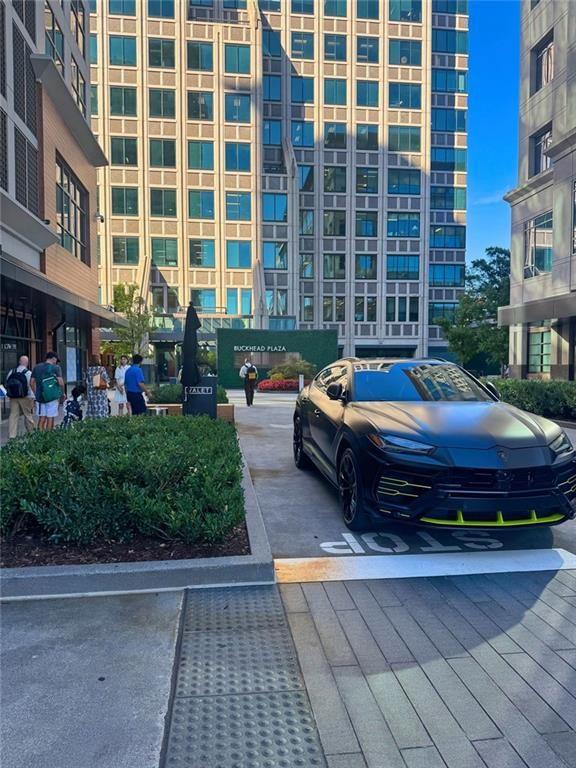3040 Peachtree Road Northwest, Unit 707 Atlanta, GA 30305 - Photo 37 of 38 a wooden bench sitting in front of a building