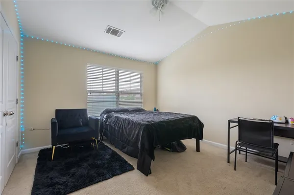 a bedroom with a bed and a chair