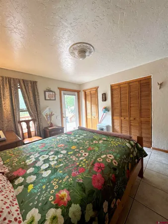 a bedroom with a bed and a lounge chair