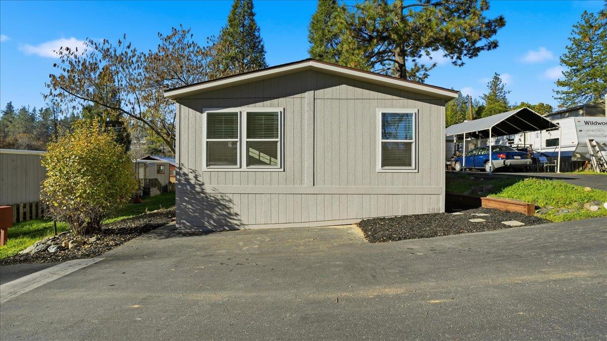 135 Ponderosa Way, Unit 14 Colfax, CA 95713 - Photo 1 of 37 a front view of a house with a garden