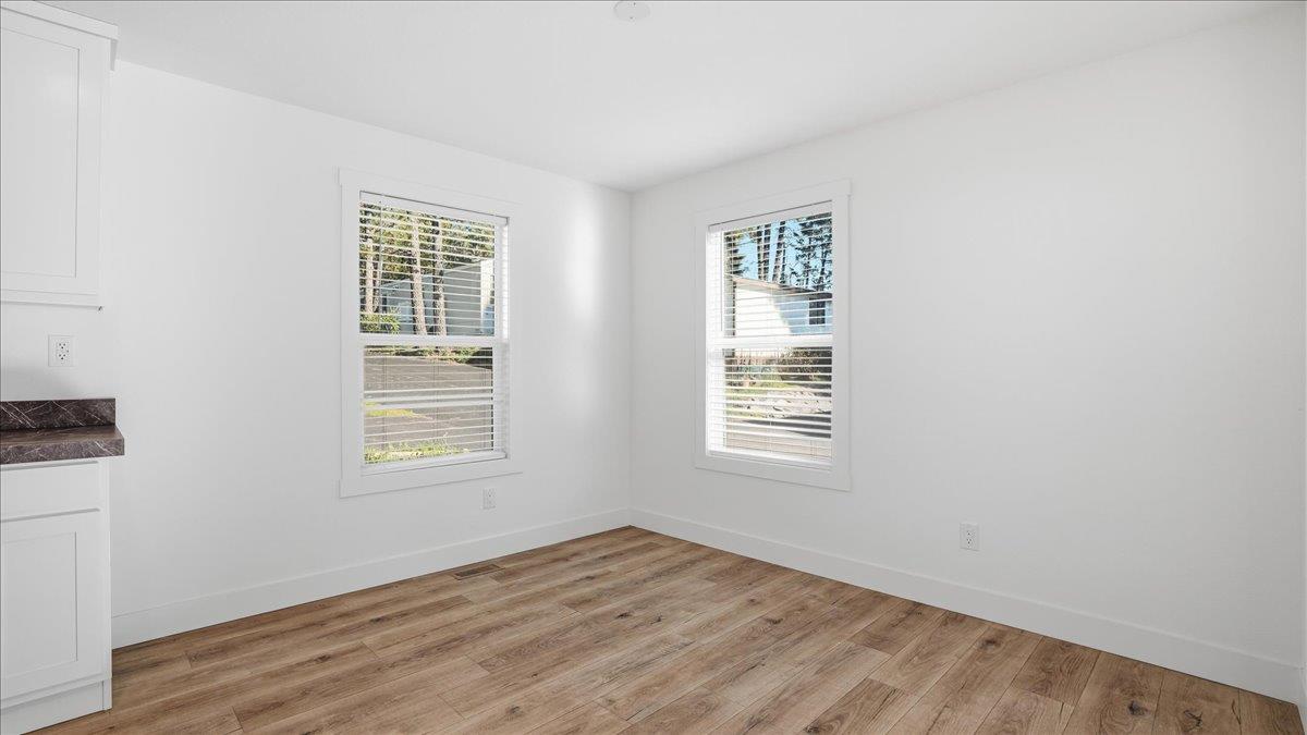 135 Ponderosa Way, Unit 14 Colfax, CA 95713 - Photo 11 of 37 an empty room with wooden floor and windows