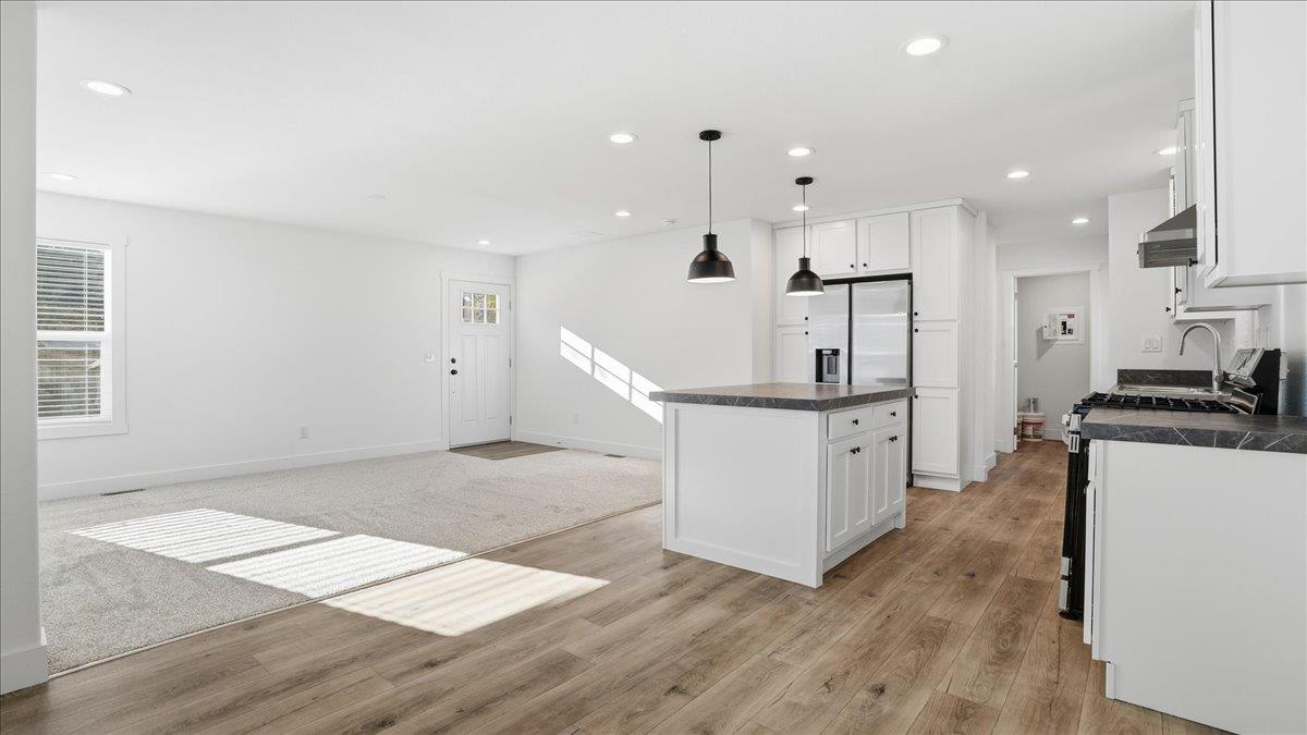 135 Ponderosa Way, Unit 14 Colfax, CA 95713 - Photo 13 of 37 a open kitchen with white cabinets and wooden floor