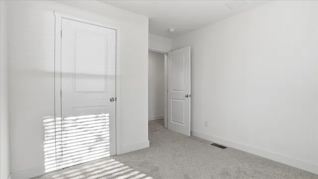 a view of a closet area with an empty room