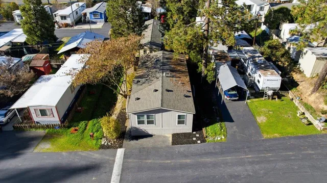 an aerial view of a house with a yard and garden