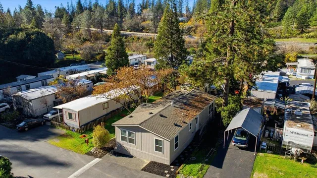 an aerial view of multiple houses with yard