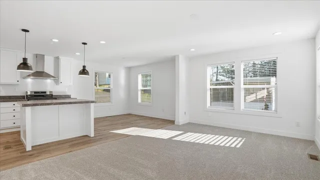 a view of kitchen with windows and ceiling fan