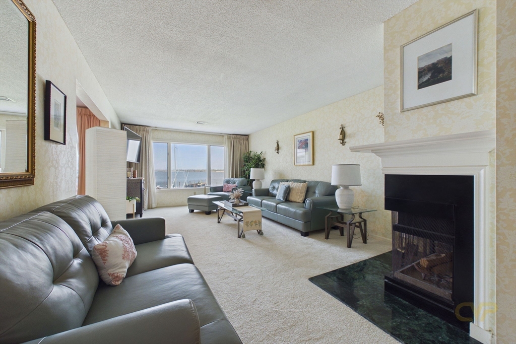 700 Shore Drive, Unit 509 Fall River, MA 02721 - Photo 5 of 25 a living room with furniture and a fireplace