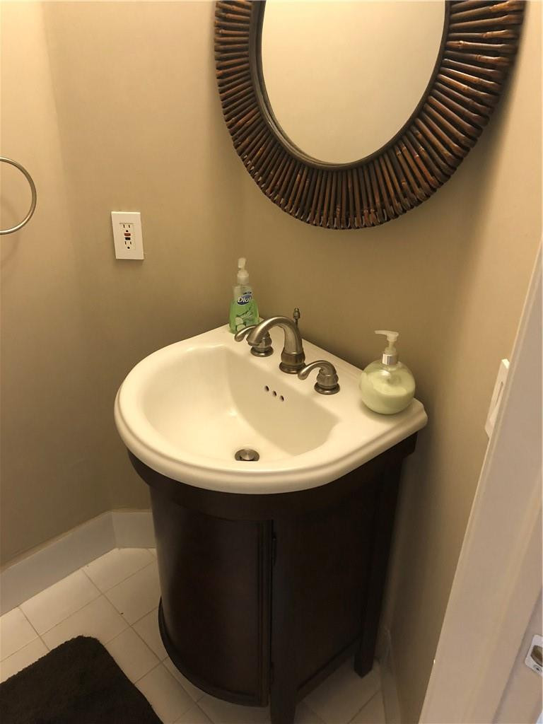 14309 Southwest 96th Street, Unit 505 Miami, FL 33186 - Photo 6 of 11 a sink sitting under a bathroom mirror