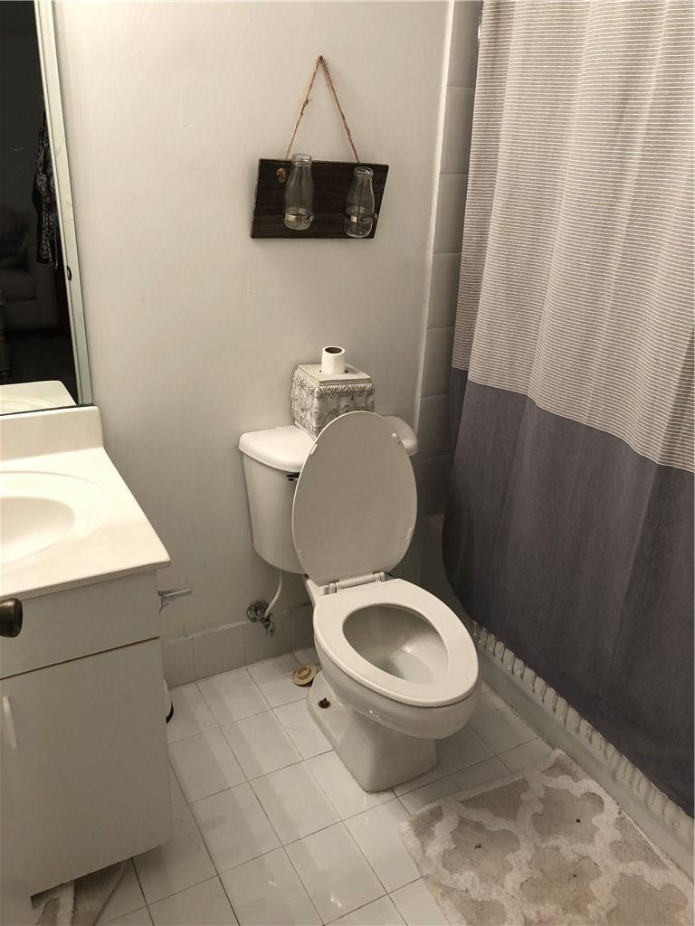 14309 Southwest 96th Street, Unit 505 Miami, FL 33186 - Photo 8 of 11 a white toilet sitting next to a small sink