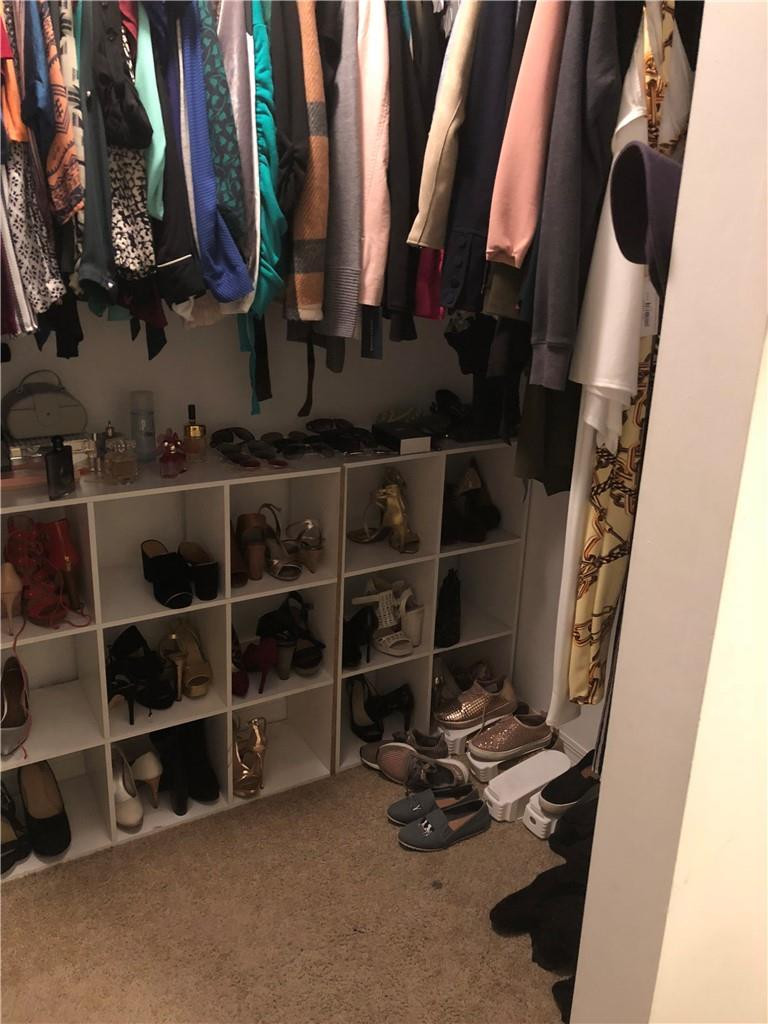 14309 Southwest 96th Street, Unit 505 Miami, FL 33186 - Photo 9 of 11 a view of walk in closet with clothes and shoes