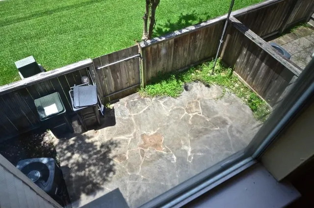 a wooden bench sitting in front of a building