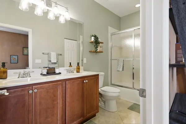 a bathroom with a granite countertop sink a toilet and a mirror