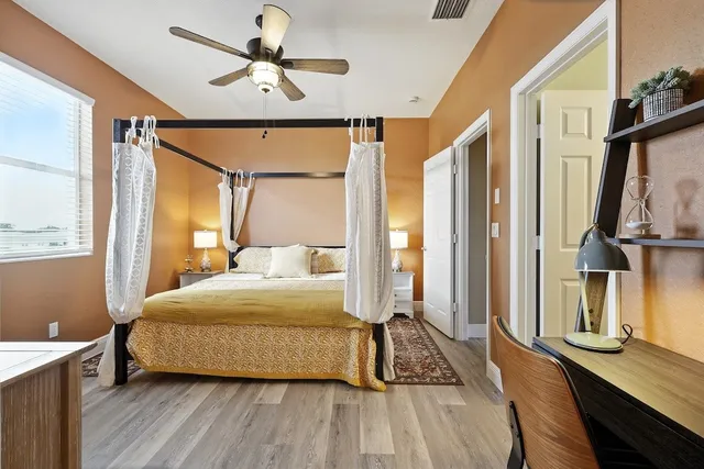 a bedroom with a bed and a chandelier