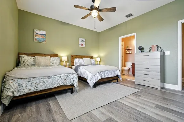 a bedroom with a bed and a chandelier