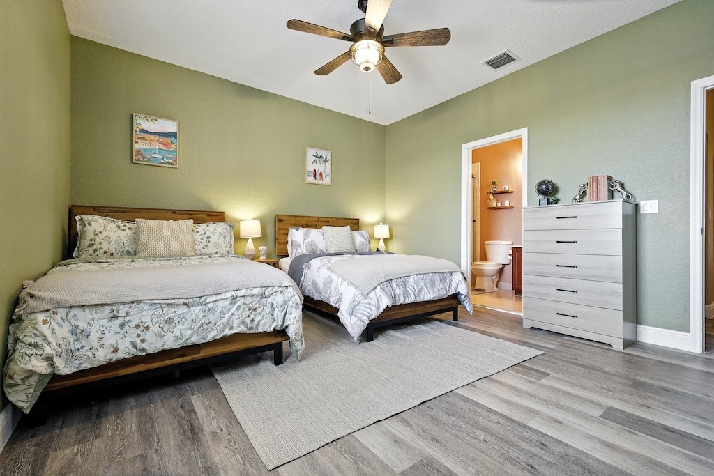 263 Provence Place Vero Beach, FL 32960 - Photo 15 of 33 a bedroom with a bed and a chandelier