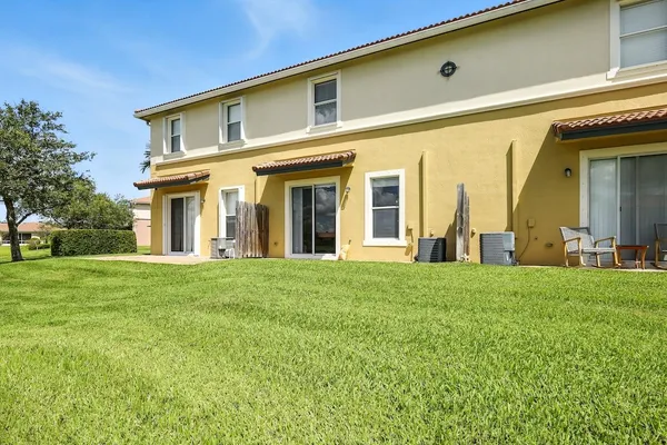 a view of a house with a backyard