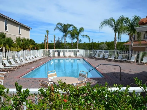a swimming pool with outdoor seating and yard