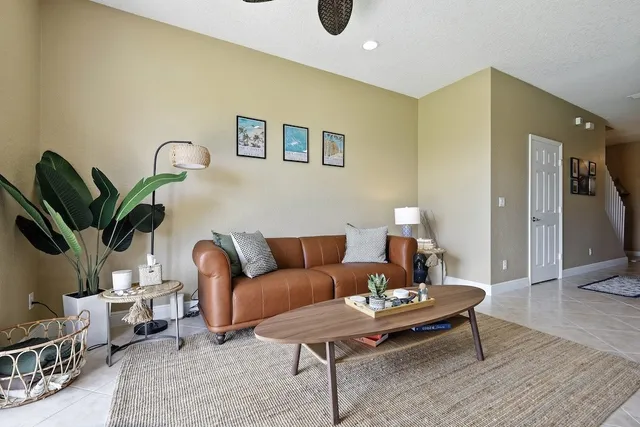a living room with furniture and a potted plant