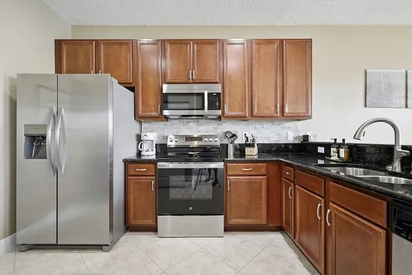 a kitchen with granite countertop stainless steel appliances and cabinets