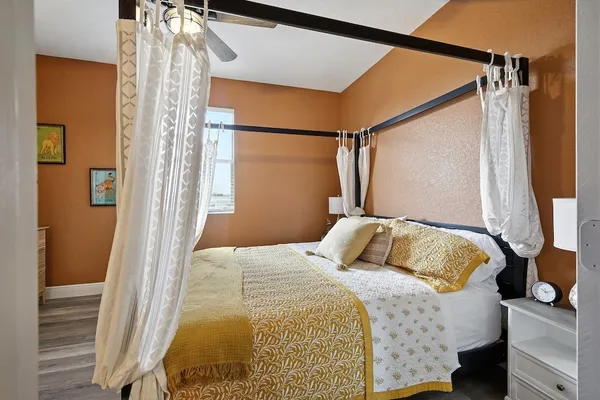 a bedroom with a bed and a window